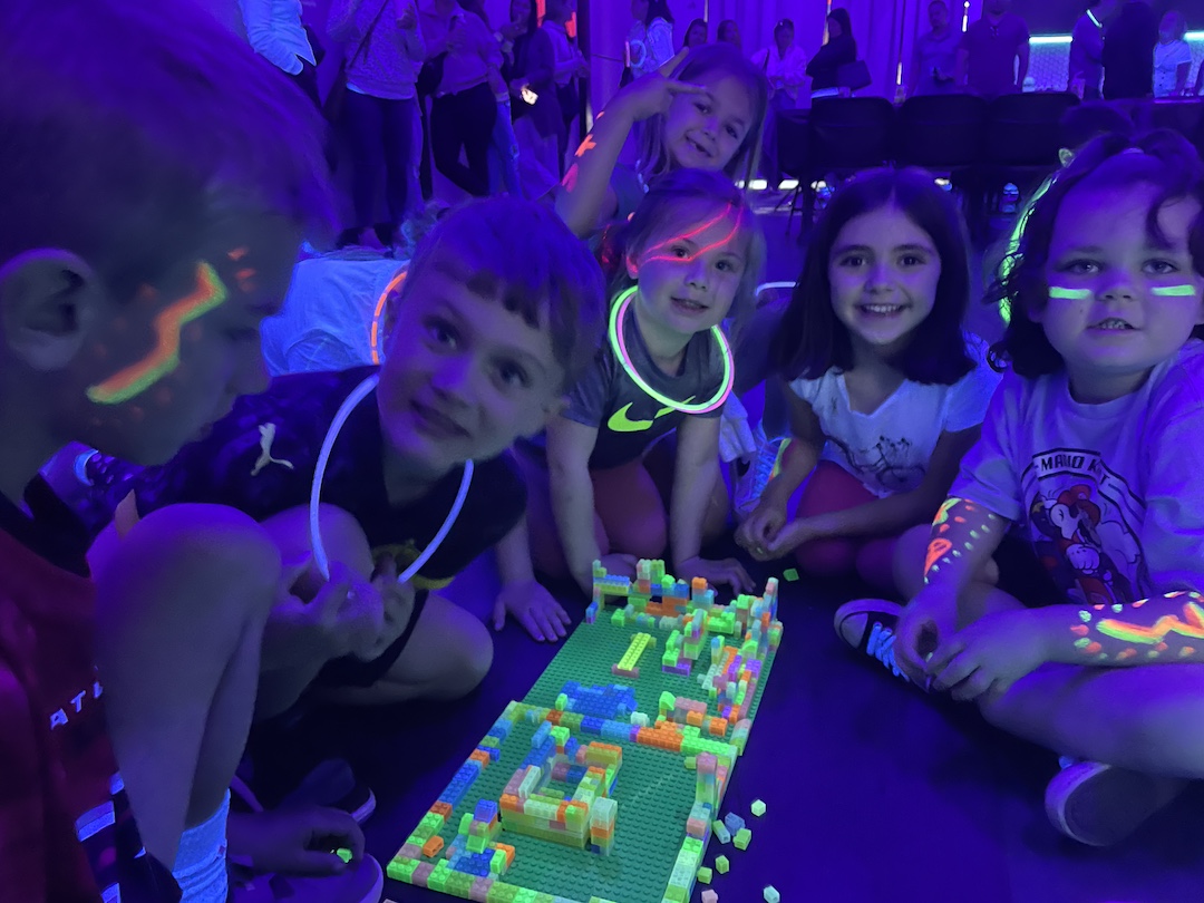 Kids creating together during a glow party