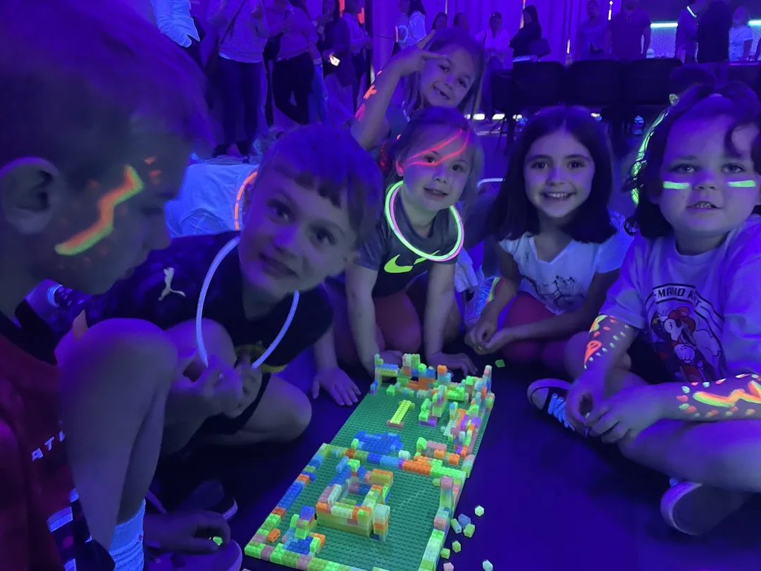 Kids creating together during a glow party